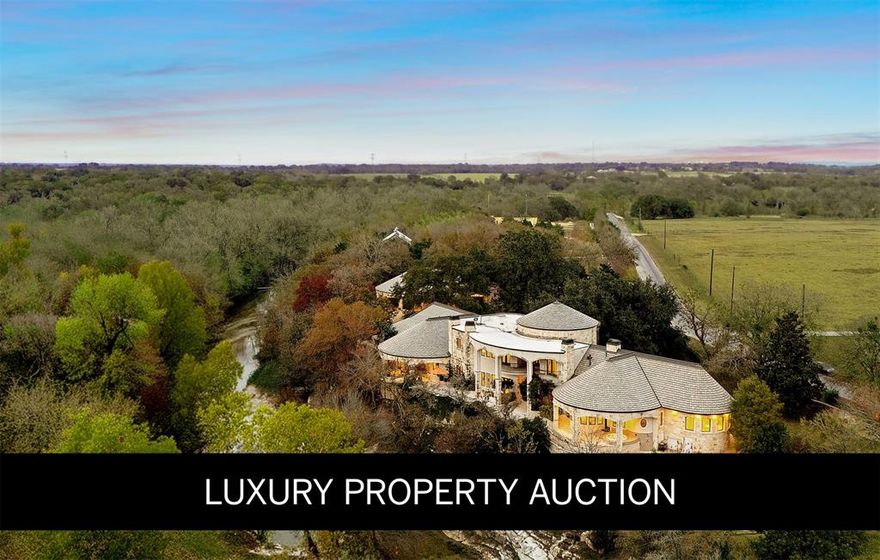 LUXURY PROPERTY AUCTION: 13–28 FEBRUARY. Accepting Starting Bids Through 12 February. 
An extraordinary legacy opportunity awaits at Oxbow Overlook, a magnificent architectural masterpiece perched high above Salado Creek on thirteen pristine acres of meticulously manicured Texas landscape. This incomparable estate captures the essence of refined Hill Country living with its dramatic wrought iron entry gate, stunning courtyard, and mature live oaks creating a majestic approach. A striking 24-foot entry wall of iron and glass reveals a grand foyer crowned by a 31-foot copper dome ceiling hovering above a sweeping quarter-sawn oak staircase with copper accents. Seven fireplaces, including an outdoor feature, complement the native limestone construction throughout. Creek-side walls, terraces, and outdoor living spaces conform to the bluff's natural curve, offering spectacular vistas across the property and showcasing exceptional craftsmanship with thoughtful conveniences at every turn..