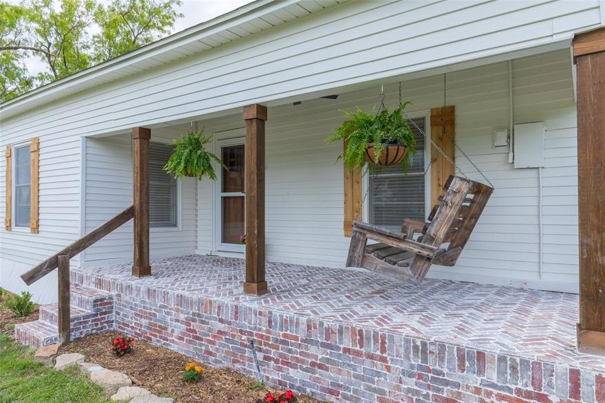 Owner agent. Modern charm meets country living on 3.8 acres. This fully renovated 3 bedroom 2 bath home offers elevated design and timeless character. Restored original wood floors set the tone, while the reimagined layout creates a seamless, open feel with a dedicated dining space just off the kitchen.  Featuring the Original Exposed Shiplap which displays the true Character of this Home! The kitchen is a true showstopper—crisp white cabinetry, rich dark granite, and striking gold accents paired with a newly added pantry for both beauty and function. Fresh paint inside and out, new shutters, and a stunning brick front porch give this home that picture-perfect first impression. Step outside to your own private retreat—fenced backyard, carport, and a tank, all surrounded by wide-open space and endless possibilities.