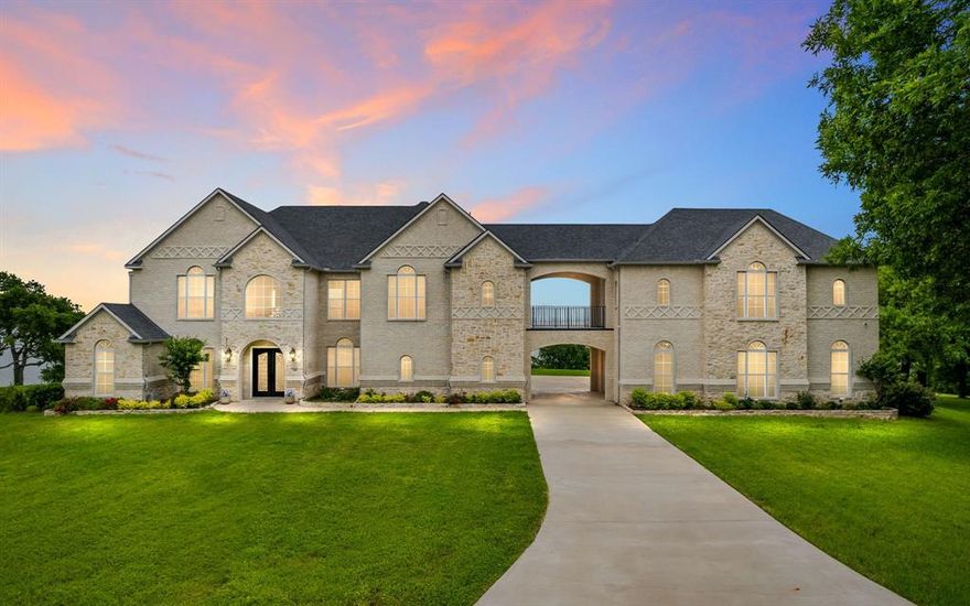 An incredibly rare opportunity! Stunning lakefront property on the pitch of the peninsula on Lake Ray Hubbard. Unobstructed prime views, direct lake access, and dockability. Whether you're looking for a weekend getaway or your forever retreat, this is the place to be for peace and tranquility that only being on the water can bring! This gorgeous custom built lakefront home is a showstopper from the moment you walk in as you're welcomed by a grand staircase in the foyer with views of the water as you enter. As a home built for entertaining, the intentionally defined yet interconnected spaces flow easily with this functional open concept floorplan. Designated office with french doors. Primary bedroom downstairs with spa like ensuite. Upstairs game room and flex space, 3 additional bedrooms each with ensuite bathrooms, and access across the breezeway balcony to separate entry 920 Sq Ft suite with supporting kitchen, full bathroom, and closet. Sunrise to sunset, live the life you desire.