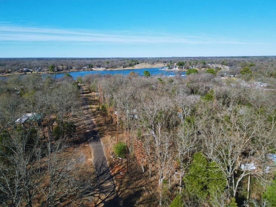 One of four adjacent lots in Hidden Hills Harbor within walking distance of the lake and a secluded community beach. Located in a quiet, established lake community approximately one hour from Dallas and Tyler, this property offers a peaceful, nature-filled setting ideal for a full-time home, weekend retreat, or investment opportunity. Buyer and buyer’s agent to verify all information, including utilities, restrictions, and intended use.
