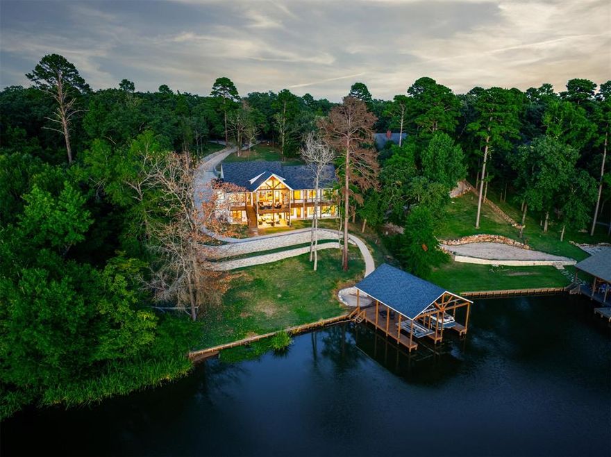 LUXURY LAKEFRONT HOME ON LAKE CYPRESS SPRINGS

Located in the prestigious Lands End community, this custom lakefront home offers refined living on nearly one acre with approximately 125 feet of private shoreline and expansive sunset views. The property includes a premium boathouse with boat and jet ski lifts.

A gated entrance and scenic two-mile approach lead to a modern farmhouse design featuring expansive windows, 16-foot coffered ceilings, and a grand living room with stone fireplace and double-tier chandelier. The chef’s kitchen is appointed with a quartz island, navy tile backsplash, high-end appliances, and generous storage.

The main level includes three ensuite bedrooms, highlighted by a primary suite with spa-style wet room and soaking tub. The lower level offers three additional ensuite bedrooms, a kitchenette, bar area, and two game rooms, all with lake views.

Outdoor living features a vaulted covered porch with fireplace, dedicated grill patio, and mounted 65-inch outdoor TV. Additional amenities include a three-car garage, designer landscaping, and the home is offered fully furnished for a move-in-ready lake retreat.

Exceptional lakefront living on one of East Texas’ most sought-after lakes.