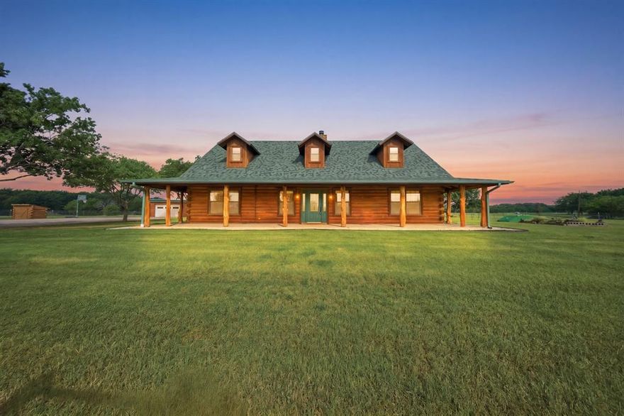 Some homes check boxes, This one transforms how you live! Welcome to Green Acres—where the simple act of coming home becomes a reset, and the noise of the outside world slips quietly out of reach. Discover this stunning property with Gated Entrance on 5 fenced acres! This estate offers rare privacy backing up to Lake Ray Roberts Corps of Engineers land. Designed for both refined living & outdoor enjoyment. Residence showcases rich wood interiors, WB fireplace,& wraparound porch capturing serene, wooded views. The outdoor living experience is truly elevated, featuring fully equipped covered kitchen with granite countertops, ice maker, sink, mini fridge, grill, griddle,& sitting area perfect for entertaining year-round! 2 overhead propane heaters, ceiling fans, electric shades,& fireplace create comfortable setting every season. Property comes with private well,storm cellar, generator hookup,& covered RV storage. The 40x60 detached 4-stall shop-barn offers exceptional versatility, complete with storage & office-man cave,bath, cedar closet. Located just 8.4 miles from DNT extension & in PPISD. Ideal for lake lovers, outdoor enthusiasts, & those seeking private country living! please transaction desk for a full list of upgrades and updates