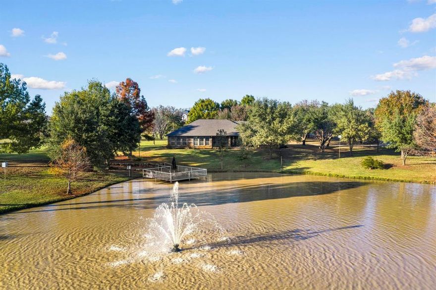 JUST REDUCED! This almost 3 acre ranch with a circular drive has so much to offer! 4 bedrooms, 3 full baths, one with a steam shower. Bedrooms have built ins and one has a cedar closet. Oversized primary bedroom with views of the pond. Updates to the kitchen, baths and floors since 2020. Heated floors in 2 baths. New carpet in 2 bedrooms in 2026. Large utility room with sink and room for second fridge. New roof in 2024. Shared stocked pond with lighted fountain and your own private dock! Recently fenced in area for your fur babies, your own chipping and putting green, workshop in garage with storage galore and an electronic screened in carport with TV for entertaining or use for as a carport. Aerobic Septic, private well for sprinklers and city water for the home. Don't miss this unique property in close proximity to Argyle, Flower Mound and Denton. Make an Offer!