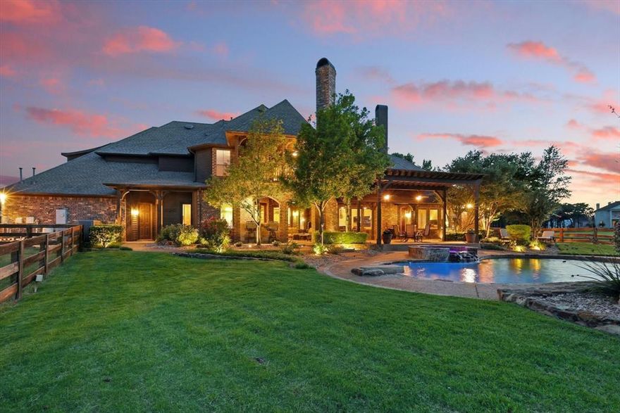 Welcome to your dream estate, nestled behind a gated entrance on 6.8 beautifully maintained AG-exempt acres. This one-of-a-kind property blends refined luxury with country living, offering the ultimate in privacy, comfort, and functionality. Step inside to discover rich hickory scraped wood floors, 4 spacious bedrooms, 7 bathrooms, a spacious office with custom cabinets, and a dedicated hobby room complete with a cozy fireplace.  The gourmet kitchen is a chef’s dream with an open layout that flows seamlessly into the main living areas. Entertain with ease thanks to a full wet bar equipped with a wine fridge and built-in ice maker, and a whole-home surround sound system that sets the perfect mood. The luxurious primary suite includes an updated spa-style shower and his and her closets, while the upstairs game room with a full bar and media room with a 3D projector and private bathroom provide endless entertainment. Step out onto the balcony for elevated views of your serene surroundings. Step outside to an entertainer's paradise: a heated saltwater pool with spa, an outdoor shower, and a large covered patio boasting a built-in kitchen and fireplace, ideal for year-round gatherings. Equestrian and hobby enthusiasts will appreciate the 66x42 horse barn with 6 custom stalls, tack room and wash rack, as well as the 40x60 fully insulated metal workshop with electric—perfect for any project. A fully stocked pond with an aerating fountain adds natural beauty, while the 750-ft deep well with a powerful 2-stage 5 HP pump to keep your pond and barn troughs full at all times. An R5 tornado shelter provides peace of mind. This estate offers a rare opportunity to enjoy upscale living with agricultural advantages— in highly rated Argyle ISD and just a short drive from city amenities. Don’t miss your chance to own this extraordinary retreat.