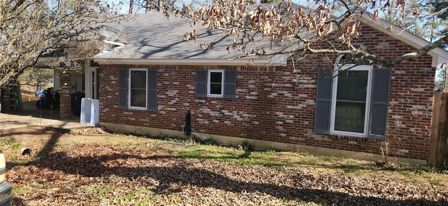 Peaceful Cross Lake environment in a small, quiet, gated neighborhood with shared access to community boat dock. The open floor plan features a beautiful wood burning fireplace. Recent updates to the home include new paint, light fixtures, and fans throughout. New HVAC unit and storm windows installed in 2023 and new hot water heater in 2024. This beautiful 3 bed, 2 bath home has a large primary bedroom with private bath, featuring a garden tub, separate shower, and 2 walk in closets. Includes expansive carport and covered deck with picturesque view. The home is located next to the American Legion for easy access to a boat launch and just down the road from Orlandeaux's fabulous restaurant.