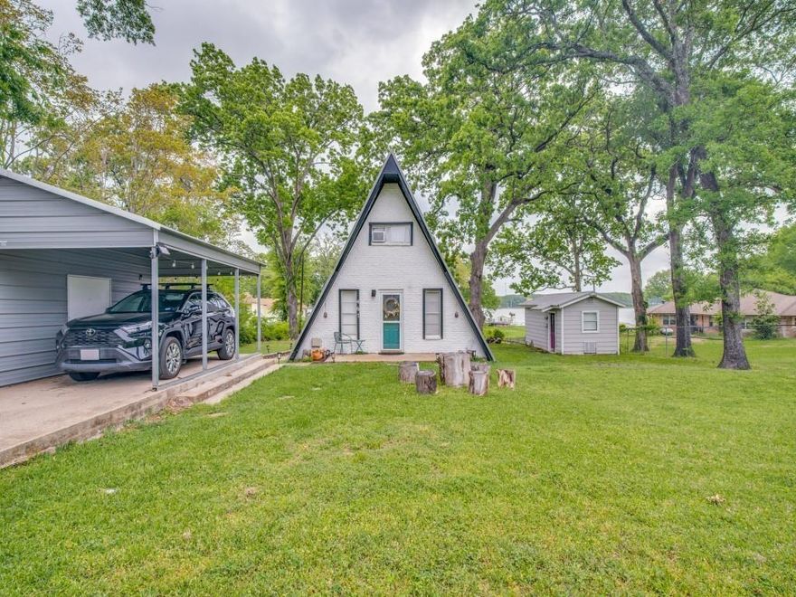 Enjoy lake living in this adorable A-frame home with gorgeous views from the living room and deck. Perfect for a weekend getaway with family and friends! Includes a separate building with full bath and laundry, plus a covered carport with storage. Boat ramps just minutes away—don’t miss this vacation home opportunity!