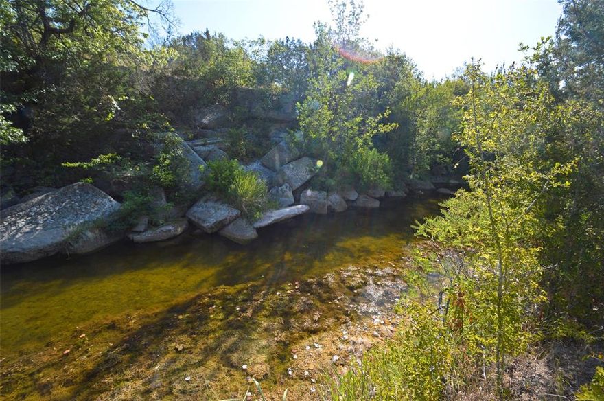 South Rocky Creek Ranch is a great combination of beautiful hill country with gorgeous panoramic views and 1700+- ft. of South Rocky Creek. The creek has nice holes of water even now with the present drought and don't underestimate the amount of water flow it will have during a normal rain season. This ranch is great for hunting and has numerous sites for a new home or cabin! The property has large beautiful trees, elm, oaks, cedar, mesquite, and an abundance of cover for the wildlife, deer, raccoons, etc. There is a quaint old home place on top of the hill where rocks are stacked. You can find an occasional arrowhead. Lots of Texas history here! Explore and enjoy! Electricity is nearby and a water well will need to be drilled. Acreage of 125.5 is approximate and will be determined by new survey. This ranch would be perfect for a full time home, retirement ranch or a great weekend getaway! This property is only 1 hour from Austin and you will love the secluded peaceful countryside!