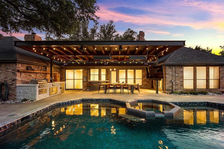 Tucked away on a quiet cul-de-sac in the heart of Dallas and zoned to highly sought-after Plano ISD! Inside, rich wood flooring, soaring ceilings, custom wainscoting, and designer touches set the tone for the elegant yet inviting interior. The grand living area centers around a striking brick fireplace framed by custom built-ins. Expansive living spaces flow effortlessly for entertaining while still maintaining an intimate and comfortable feel for everyday living. Chef’s kitchen was designed to impress with an oversized island, SS appliances, double ovens, extensive cabinetry, and generous prep space ideal for hosting gatherings of any size. A spacious game room offers endless versatility as a media lounge, playroom, or secondary living area. Private primary suite is a luxurious escape featuring a spa-inspired bath with all the extras. Three additional bedrooms provide ample accommodations for family and guests. The true centerpiece of this exceptional property is the completely reimagined backyard, an extraordinary outdoor living experience designed for both grand entertaining and everyday enjoyment. The oversized covered patio creates a seamless extension of the home and features a fully equipped outdoor kitchen with built-in grill, hanging swings, a waterproof television perfect for game days & a stylish wet bar that opens directly from the interior for effortless indoor-outdoor entertaining. Surrounded by lush landscaping, the sparkling pool and heated spa with soothing neck roll water feature create a private resort atmosphere. Evenings are elevated around the outdoor firepit, while the private putting green adds a fun luxury touch rarely found in residential living. A beautifully sized grassy yard still allows ample room for a playset, pets, or additional outdoor activities. Additional upgrades include HVAC systems, electric vehicle charging capability + backup battery power system for peace of mind. Great location, close to multiple religious establishments!