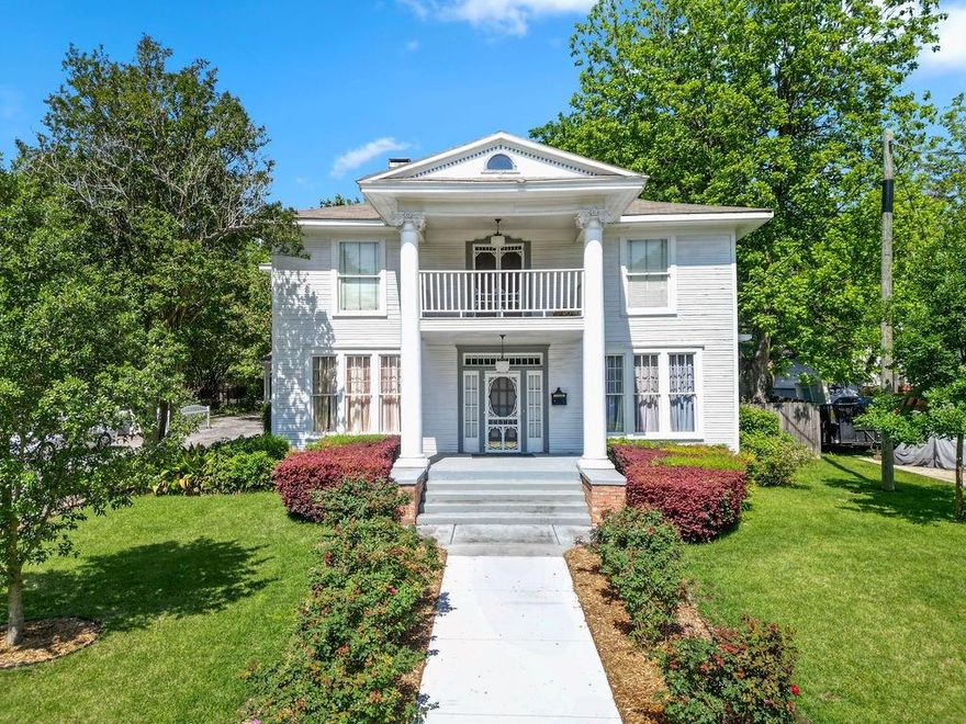 Steeped in history and quiet grandeur, the John M. Holman House, built in 1913, stands as one of Pittsburg’s enduring treasures within it's Historic District. Featured in books and films, this 4,758 square foot residence offers 8 bedrooms and 6.5baths on a beautifully kept .37 acre lot, where every space tells a story. A plaque at the front hints at its legacy, while the columned porch invites you into a home rich with character. Inside, original pine hardwood floors, soaring ceilings, intricate millwork, and soft, timeless lighting create an atmosphere that feels both elevated and warmly lived in. The grand staircase, adorned with quaint stair runners, leads you upward past the preserved tapestry in the hallway, a rare and beautiful nod to the home’s past. The main level unfolds much like it would have over a century ago, with a gracious parlor and sitting room anchored by wood burning fireplaces, a formal dining room made for gathering, a quiet study, and multiple living spaces that invite conversation and connection. Upstairs, a light filled common area opens to a balcony, offering a peaceful place to pause. With six bedrooms upstairs and two downstairs, the home offers flexibility and charm in equal measure. Four bathrooms are located upstairs, with two full baths and a half bath downstairs. Many of the bedrooms enjoy private or adjoining bath access, and two rooms serve as intimate sitting areas connected to adjoining bedrooms, once used as a private suites during its time as a bed and breakfast. The half bath can be found tucked discreetly beneath the staircase. The kitchen has been thoughtfully updated with marble countertops, custom cabinetry, a gas range, and stainless appliances, blending seamlessly into the home’s historic soul. Major systems, including HVAC, have been updated to support modern living. Well preserved and rich with history, this is more than a home. It is a place to carry forward a story that has already stood the test of time.
