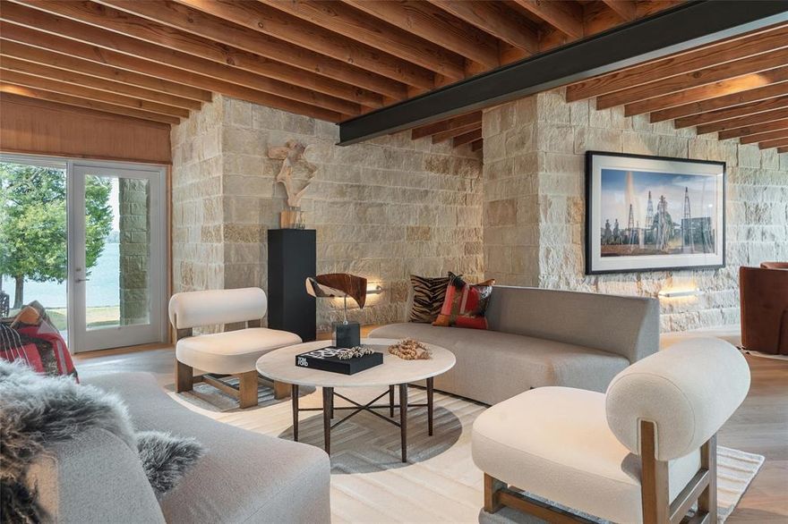 Designed by Josh Nimmo and Built by Greenwell Homes. Introducing 12590 Sea Island at Long Cove Cedar Creek Lake. A significant architectural statement on .77 acres, this newly constructed, single-level residence embodies elevated lake living through design, scale, and intention. Designed as a true art home, the architecture balances stone walls, warm beams, and expansive walls of glass that frame uninterrupted lake views, approximately 227ft of water frontage.

Multiple living rooms unfold with effortless flow, creating distinct yet connected spaces for gathering and entertaining. A dedicated billiards room with a built-in bar adds a refined layer of leisure, while the open-concept design allows light and landscape to permeate every corner of the home.
The thoughtfully designed one-level layout includes two private primary en-suites, offering both luxury and flexibility for owners and guests alike. Seamless indoor-outdoor transitions invite the water into daily life, blurring the line between retreat and residence. 12590 Sea Island is not simply a lake house — it is a curated architectural experience on Cedar Creek Lake, move-in ready and uncompromising in its execution.