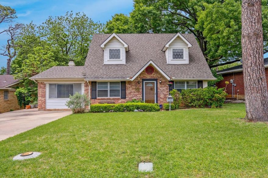 Located in the heart of Arlington, this charming farmhouse-style home offers unbeatable access to the Entertainment District, UTA, Lake Arlington, Veterans Park, the Parks Mall, and major routes to I-20 and DFW Airport. Convenience meets comfort in a setting surrounded by some of the city’s best amenities!
Charming and classic, this Americana-style home welcomes you with inviting curb appeal. Dormer windows, a large front lawn, and mature shade trees create a warm, memorable first impression. Inside, engineered hardwood floors flow through the main living areas, enhanced by abundant natural light and a crisp, neutral palette.

The open, bright kitchen has been beautifully refreshed with refaced cabinets, updated countertops, subway tile backsplash, and stainless steel appliances—offering both character and everyday function. The flexible layout includes two living areas, a cozy corner fireplace, and a first-floor bedroom ideal for primary use, guests, or a home office. Upstairs, two generously sized bedrooms flank an updated full bathroom and feature spacious closets for storage.

Step outside to a large level yard space with mature trees, a covered patio perfect for relaxing or entertaining, and a storage shed tucked neatly in the corner. Yard is ready for your vision and has many possibilities. 

This home blends charm, practicality, and a prime Arlington location