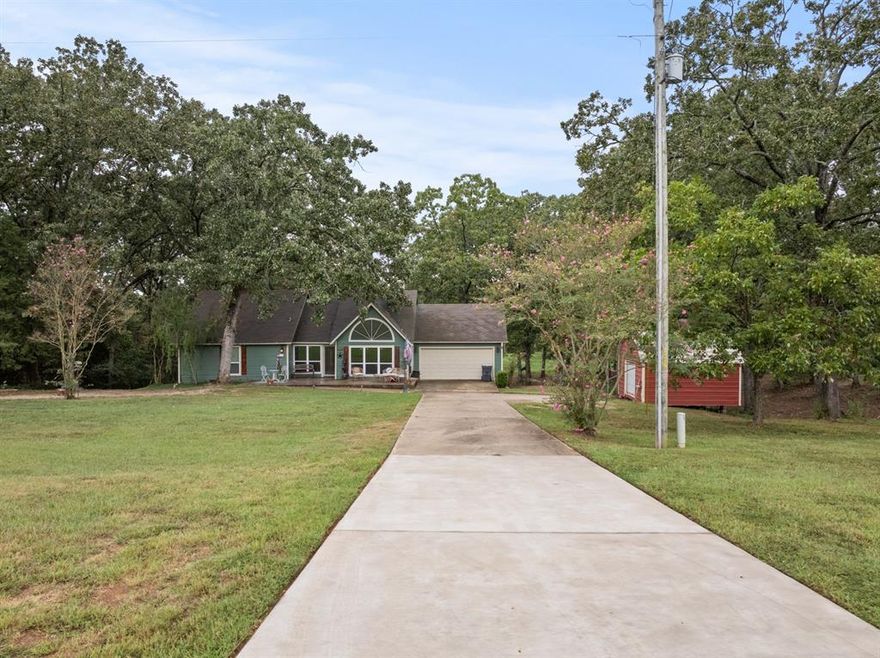 Nestled on almost 5 acres on a peaceful rural property. This versatile and well-maintained home offers the perfect blend of comfort, space, and functionality. This home has two bedrooms, two full bathrooms and an attached two car garage. Step inside to find high vaulted ceilings which provides country elegance with modern charm. Seller's pride of ownership in this one-of-a-kind home includes new HVAC system, newer hot water heater, new flooring, new windows, and a new patio deck in the backyard for all those cookouts and watching all that mother nature has to offer. The long concrete driveway to your front door adds to the convenience and accessibility not to mention value. Located in the highly acclaimed Chapel Hill ISD. Close in proximity to NTCC. (Northeast Texas Community College). Within minutes of your new home, you can also enjoy the lively downtown area of Mount Pleasant where you are sure to find a variety of shops and dining. Get your Boots on y'all and call for your private showing and come see what this is all about.