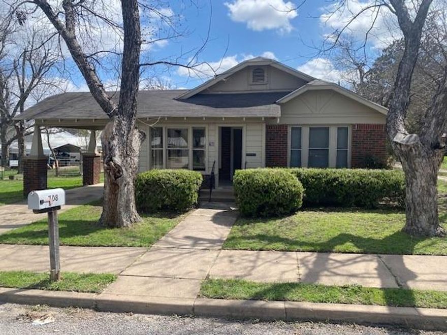 Charming craftsman style brick home that is appealing to a first time home buyer or an investor. This home has lots of character with its classic brick and front porch with a attached carport. The home sits on a corner lot with some large Pecan trees and big fenced back yard for kids to play in. The home is a two bedroom 1 bath with a spacious living area and a formal dining room. The home has original hardwood floors throughout most of the home and some tile flooring in the back. The dining room has a built in china cabinet that is perfect for the family china. This home has had some updating including new foundation repair with 5 year warranty. This home is a must see to appreciate.