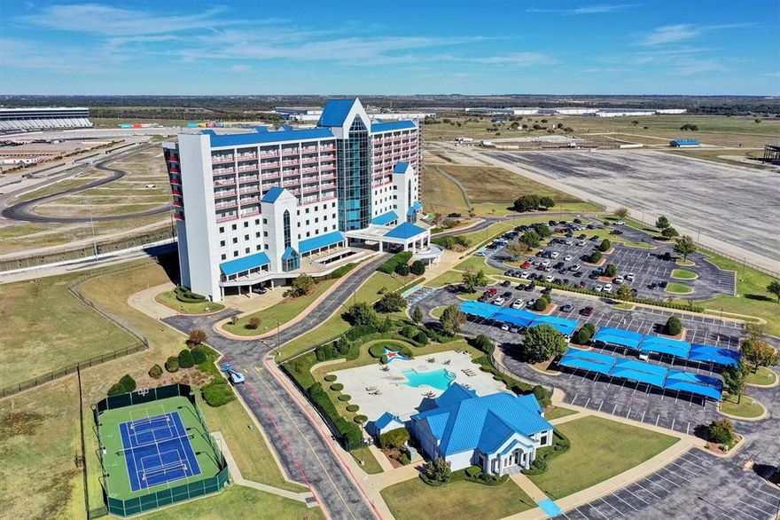 Ever Watched a Race From Your Living Room? ?? Lone Star Tower Penthouse, currently used as Condo Office. Discover luxury living with front-row views of Texas Motor Speedway! This fully renovated 2-bedroom, 3-bath condo on the PENTHOUSE level offers a stylish and comfortable retreat. Step inside to an open floor plan that flows seamlessly from the sleek, updated kitchen to a spacious living area, perfect for entertaining or relaxing. Expansive windows showcase prime views of the speedway and rooftop access to stadium seating to allow you to enjoy race day excitement right from home—a dream setting for motorsports fans! The gourmet kitchen boasts stainless appliances including a Viking Professional range, quartz countertops, and custom cabinetry, ideal for everything from quick meals to dinner parties. The primary suite features a walk-in closet and en-suite bathroom with a glass-enclosed shower, while the second bedroom offers versatility for guests or as a home office, with an en-suite bath. This vibrant community provides resort-style amenities, including a clubhouse, pool, hot tub, and a fully equipped fitness center. For sports enthusiasts, on-site tennis, basketball, and pickleball courts offer plenty of activity options. Whether you’re looking for a full-time home, a live-work arrangement or a weekend getaway, this condo combines excitement, relaxation, and convenience. Don’t miss this rare chance to enjoy an unbeatable view and luxurious lifestyle—schedule your tour today! Currently being used as a corporate office, so it can be residential or office space!