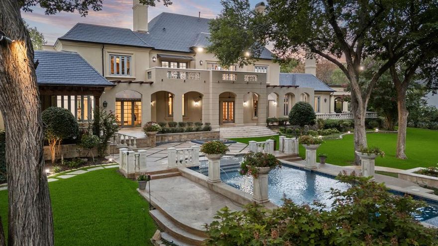 Seller offering up to $50,000 towards buyer's closing costs! Experience refined living in an 8,300+ -square-foot timeless, French château–inspired estate, perfectly positioned along the fairway in one of the area’s most exclusive 24-7 gated and guarded communities. Blending old-world elegance with modern luxury, this residence features five spacious bedrooms, each with an ensuite bathroom and walk-in closet, providing privacy and comfort for family and guests alike.
Inside, soaring cathedral ceilings with carved wood beams, oversized windows and abundant natural light create a grand yet inviting atmosphere. The primary suite is a serene retreat with dual over sized closets, dual vanities, fireplace, terrace, a private exercise room, and breathtaking views of the manicured grounds. A private guest suite with exterior access ensures comfort and privacy for visitors.
Designed for elevated living and entertaining, the home features a gourmet kitchen, multiple elegant terraces, a balcony overlooking the lush landscape, and an expansive outdoor area featuring a new kitchen with bbq grill, sink, pergola, infinity-edge pool, spa, and sunken fire pit. A dedicated theater room offers the ultimate cinematic experience adjacent to a game room with fireplace and bar.
Recent updates, including a new roof, complement the property’s enduring architecture. The four-car garage motor court provides convenience, while the location offers award-winning schools and quick access to both DFW and Love Field airports, as well as fine dining, shopping and health care.
This exceptional estate delivers timeless design, luxurious amenities, and an unmatched fairway setting - one of the iconic homes in The Estates at Tour 18.