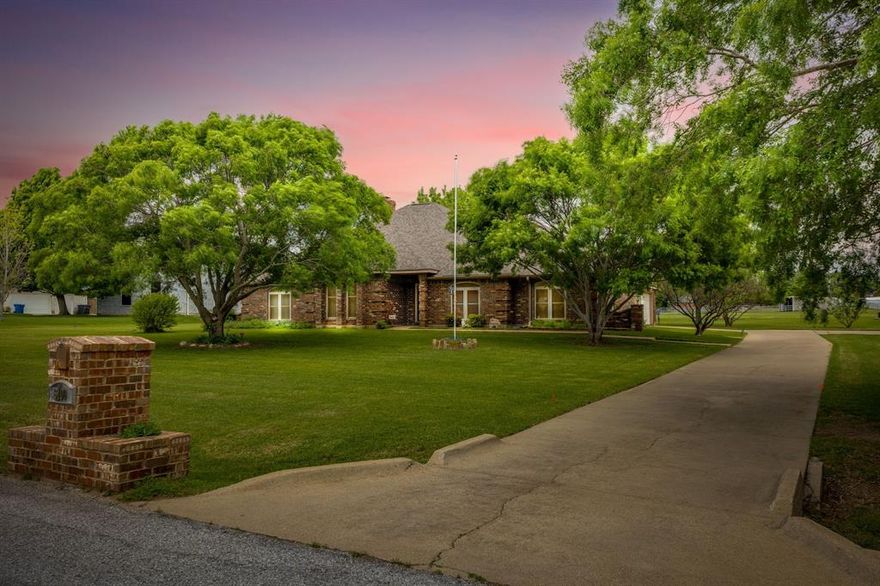 Stunning Texas sunsets! Come see this meticulously maintained, country-adjacent property. This custom 1990 home offers four spacious bedrooms, three full bathrooms, a formal dining room, a huge laundry room, a MIL entrance, and an oversized garage. The primary bedroom features a private ensuite bath and a unique horseshoe-style wraparound closet, creating a functional and luxurious retreat. Designed with flexibility in mind, the home is ideal for multigenerational living. One wing includes the primary suite, two additional large bedrooms, and a full bath. The opposite side offers a private fourth bedroom with its own private entrance from the driveway, a full bath, and an oversized utility room. The kitchen has abundant counter and cabinet space, along with a central island that provides plenty of room for multiple people to cook, entertain, or even film a TikTok cooking session. The living room features a stunning decorative wood-burning fireplace, built-in shelving, a tall tray ceiling, and two large, picturesque windows.  Step outside to a huge covered patio.  The 1.23-acre lot is covered in lush St. Augustine grass, so thick that you can walk barefoot across the whole thing. There is a small metal shed to store your yard toys. All of this is located in the highly regarded Mansfield ISD. Recent updates include: New windows (2015) New HVAC system (2012) New roof (2023) Water heaters replaced in 2008 and 2020.