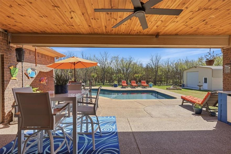 BRINGING SEXY BACK...and NO CITY TAXES!!! Experience the perfect blend of peaceful country living and city convenience just minutes from Fort Worth and its vibrant dining, entertainment, and employment hubs. Located within highly sought-after Aledo Independent School District, this stunning, resort-style property has been meticulously maintained and thoughtfully designed for both everyday comfort and unforgettable entertaining.
From the moment you arrive, you’re welcomed by a grand wrought iron and glass entry door that makes a striking first impression. Inside, the home showcases quartz countertops, Luxury Vinyl Plank wood and tile flooring, and an abundance of cabinet and closet space. Every detail reflects pride of ownership and quality craftsmanship.
Step outside to your private backyard retreat, complete with a sparkling pool and a spacious covered patio with outdoor kitchen. Mature trees surround the property, creating shade, privacy, and a serene atmosphere perfect for relaxing or hosting guests. New wood privacy fence creating privacy from street side. Large pool deck area for laying out or having a party. 
This property is loaded with upgrades and functional features, including...
 18’ x 18’ climate-controlled brick workshop or second garage—ideal for hobbies, storage, or a man cave
 22’ x 36’ enclosed garage and workshop. Foam insulated. 
 Sprinkler system. Rain gutters with leaf guards around the entire home
 3,000-gallon water storage tank with vinyl equipment shed, continuously supplied by the well
Whole-home water filtration system
Oversized wrought iron fenced backyard
 Auto-lighting in pantry, hallway, and primary closet
 Fireplace is real wood burning. 
 Pool recently reconditioned and absolutely stunning.
Blending luxury, functionality, and a prime location near everything Fort Worth has to offer, this property delivers the best of both worlds—quiet rural charm & privacy with quick access to city amenities.
