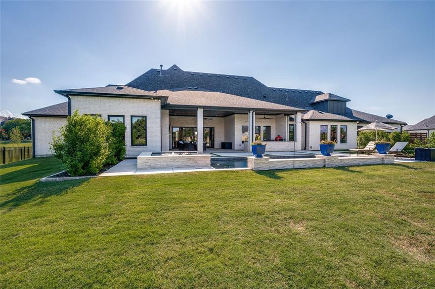 Experience the pinnacle of modern luxury in this stunning single-story Dave Williams Custom Home on a spacious 1.01-acre lot. This 5-bedroom residence offers ensuite baths for each room, plus a dedicated study, activity room, media room, and a powder-pool bath—designed for comfort, privacy, and functionality. Just .5 miles from Preston, with City Water, City Sewer, and Natural Gas. NO MUD. NO PID.
A grand circular driveway welcomes you to expansive, light-filled living spaces featuring beamed ceilings and a dramatic wall of sliding glass doors that open to the outdoor living area, pool, and spa. The open-concept design flows into a gourmet kitchen with Wolf appliances, Sub-Zero refrigerator, oversized island, and a large walk-in pantry with motion lighting and built-in microwave.
Perfect for entertaining, the home is outfitted with a Control4 smart system (optional Josh AI voice control) managing lighting, sound, climate, and security—including the outdoor living area with a built-in kitchen, fireplace, and full sound system. Automated blackout shades, dimmable lighting, and programmable thermostats enhance comfort and efficiency.
The luxurious primary suite is a retreat with dual walk-in closets, private laundry, coffee bar, and spa-like bath with steam shower, dual vanities, and smart lighting. A hidden bookcase connects two secondary bedrooms, each with walk-in closets and serene views.
Enjoy movie nights in the media room with a 120 inch screen, Sony projector, and leather recliners. The adjacent activity room with wet bar is ideal for games and entertaining.

Additional highlights include a safe room-tornado shelter, dual utility rooms, server closet, motion lighting, 4-car garage with polyaspartic floors, and a full Texas attic with interior stair access. The backyard oasis features lush landscaping, Big Joe grill, griddle, bev fridge, security, automated shades, and dual fireplaces—ideal for year-round enjoyment.

Luxury, technology, and tranquility!