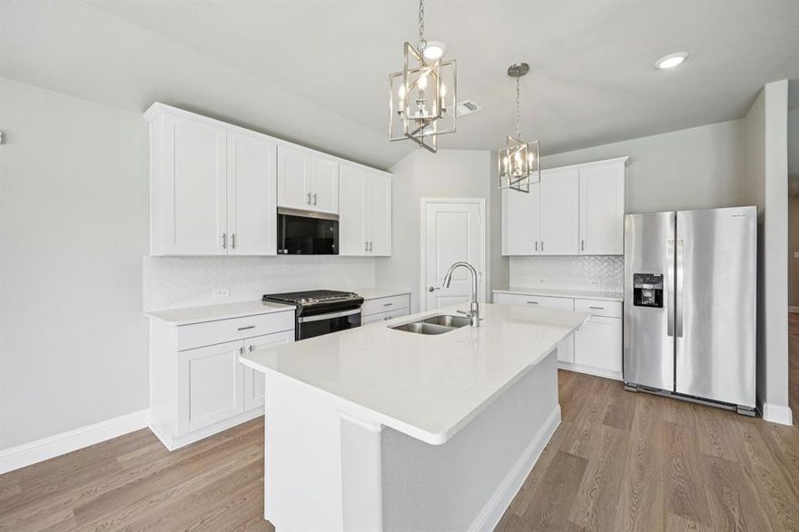 BRAND NEW energy - efficient home Dec 2025! Sip your morning coffee at the Henderson's convenient kitchen island overlooking the dining and family rooms. White cabinets with veined white quartz countertops, tan tone EVP flooring with dark beige tweed carpet.