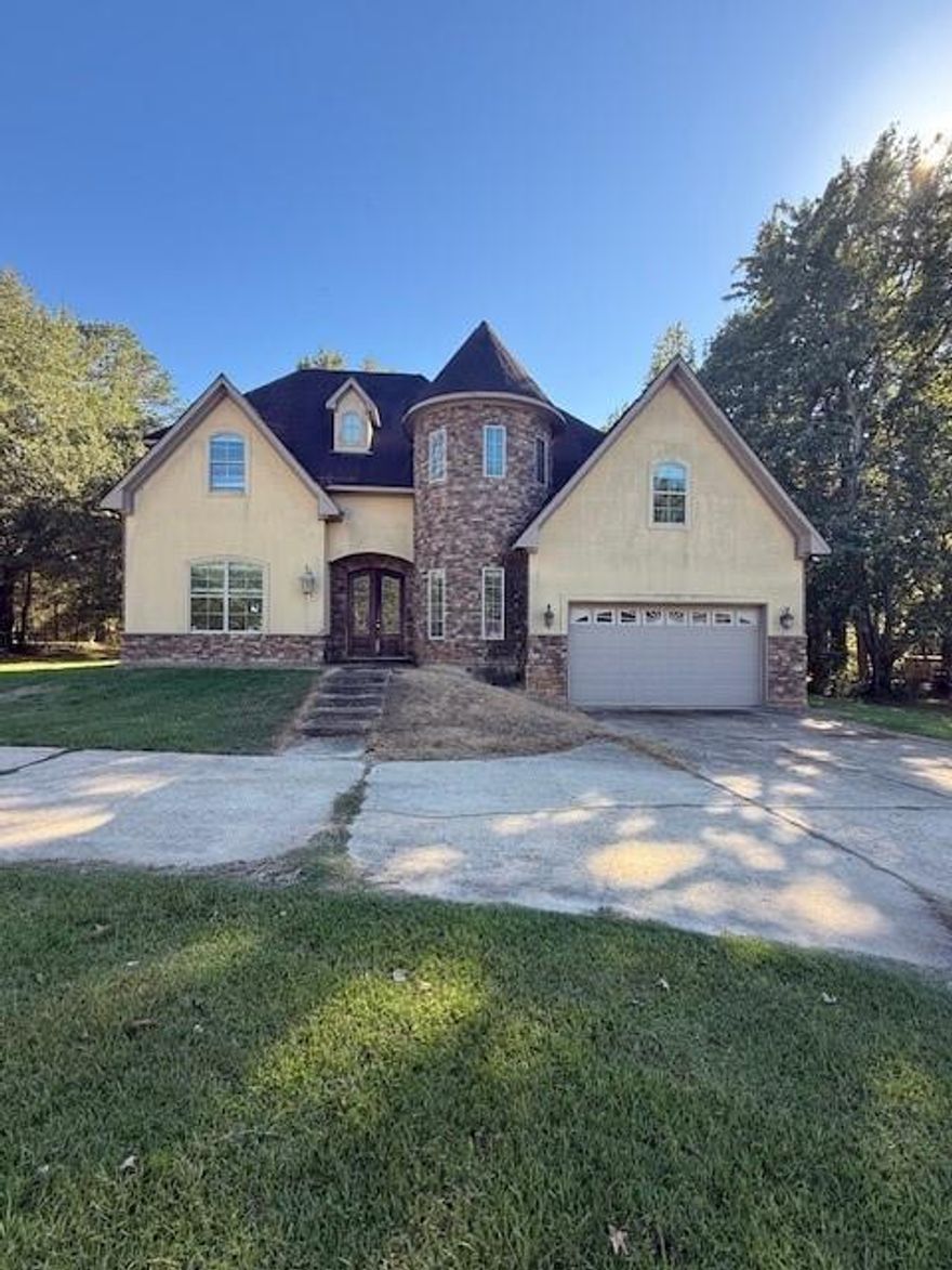 **Just Listed: Your Dream Home at 121 Honeysuckle Dr., Mansfield, LA!**

Discover this enchanting castle-like home, built in 2012, offering an impressive 3,247 sq. ft. of living space across three stories on nearly an acre (.94) of land. With 5 bedrooms and 3.5 bathrooms, this property is perfect for families or those who love to entertain!

**Property Features:**
- Inviting living room with a cozy fireplace
- Expansive game or media room on the second floor, ideal for hosting gatherings
- Luxurious master suite featuring a walk-in shower, double closets, and granite double vanity countertops
- Private mother-in-law guest suite on the third floor with an oversized bathroom, dual vanities, and a relaxing sitting bench
- Gourmet kitchen with custom cabinets, granite countertops, and stainless steel appliances
- Dedicated office space with a comfortable sitting area off the master
- Convenient half bath downstairs

The striking circular driveway offers ample parking for guests, while the vast backyard features a covered patio that overlooks the beautiful scenery.

**Incredible Opportunity:** This property is being sold as-is for the amazing price of **$259,999**, with a recent appraisal on file valuing it at **$415,000**. Any desired repairs or updates would be at a higher price point. This property just needs some TLC mostly needing new painting and flooring to bring it back to its original state. 

Don’t miss your chance to own this unique home at a fantastic value! Schedule a showing today and envision the possibilities!