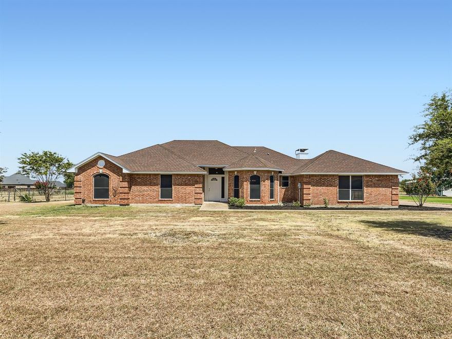 Click the Virtual Tour link to view the 3D walkthrough. Nestled away in a serene rural enclave, this red brick home offers the perfect blend of peaceful seclusion and convenience. With swift access to both US 67 and I-35, your journeys to city or countryside are effortless. Newly revitalized with fresh paint and new carpeting, the interior offers an inviting ambiance. The sunlit front room is a sprawling space designed for joyful gatherings. Two dining areas elegantly flank each side of the kitchen offering versatility for hosting guests. Escape to a haven of coziness in the second family room, complete with a warming fireplace that beckons you to unwind. 4 spacious bedrooms provide a cozy retreat for everyone. Sited on just over 2 acres of land, this home boasts an expansive backyard, providing a blank canvas for your dreams to flourish. Create an outdoor paradise, whether it's a garden, an entertainment space, or a recreational haven – the choice is yours. Welcome home!