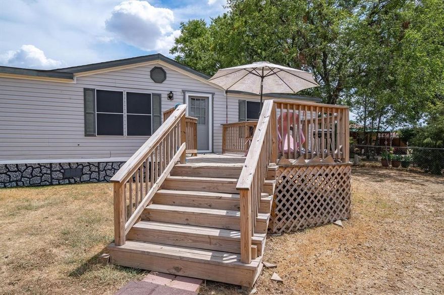 One of a Kind! Attractive & Affordable! Three bedroom, two bath doublewide mobile home located on the each of town. Fenced yard - both front & back ! Inviting deck welcomes you into the living area with built in shelves!
Updated flooring is laminate plank and fresh paint in cool, neutral colors make this home light & bright! Dining area is
open to living & kitchen. Kitchen has many cabinets, dishwasher, and electric range. Fantastic backyard deck. Master bedroom has adjoining bath with garden tub. Two secondary bedrooms. Seller Motivated to sale.