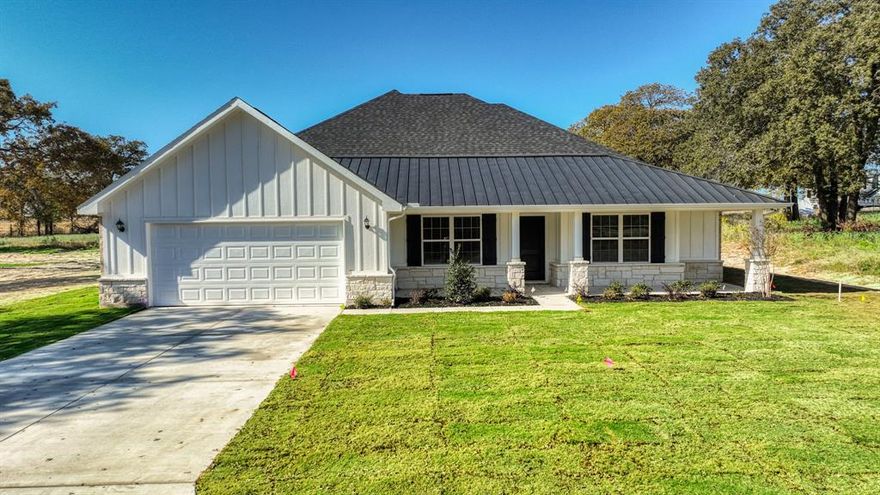 Brand-New Gold Series Home on 2 Acres in Poolville, TX
Discover peaceful country living in this brand-new John Hunter Home Builders’ Gold Series home, set on 2 private acres in the heart of Poolville. With 3 bedrooms, 2 bathrooms, and 1,983 sq ft of thoughtfully designed space, this modern farmhouse blends timeless charm with quality finishes.

Inside, the kitchen shines with leathered granite countertops, offering a stylish yet durable workspace. The open-concept living area is anchored by a hand-laid, floor-to-ceiling stone fireplace with a stone hearth perfect for cozy evenings at home.

Step outside to enjoy a professionally landscaped yard with full sod and irrigation, plus a concrete driveway for lasting curb appeal. This home is on a private water well with great water quality and comes with a 1-2-10 builder warranty for peace of mind. COMPLETION IS EARLY NOVEMBER.