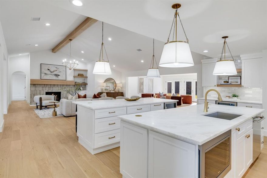 Welcome to another thoughtfully executed renovation by TK Homes LLC, known for delivering elevated design, quality construction, and homes that truly live well. Located in one of the most desirable pockets near Preston Hollow, this residence has been fully reimagined with intention from the ground up.

The interior has been transformed with added square footage expanding the great room, all-new electrical and plumbing systems, two new HVAC units, a tankless water heater, and upgraded insulation throughout — creating a home that feels as solid as it is beautiful.
Curated finishes define the space, including engineered Mohawk Ridglea Isle Oak flooring, soft-close cabinetry, 3CM marble countertops, designer tile and lighting, polished chrome hardware, and frameless glass showers with dual showerheads. A custom trim package, solid-core doors, and a fresh Sherwin-Williams palette add warmth and refinement at every turn.

At the heart of the home is an exceptional double-island gourmet kitchen — a true centerpiece for gathering and entertaining — featuring a premium JennAir appliance suite, built-in microwave, and dual beverage refrigerators that balance high function with standout design.
The versatile floor plan offers two luxurious primary suites. The main suite includes a spa-inspired bath with dual shower heads, while a private secondary primary, thoughtfully set apart, also features an en suite bath with dual shower heads — ideal for guests or multi generational living. A dedicated front office with an accent wall provides a stylish, quiet workspace.

Outdoor upgrades include fresh landscaping, an automated sprinkler system, salt-finish concrete patio, exterior lighting, epoxy-coated garage floor, and a gas line for grilling. Ideally located near top schools, shopping, dining, and major Dallas conveniences, this move-in-ready home offers a rare blend of modern luxury, proven craftsmanship, and lasting quality.