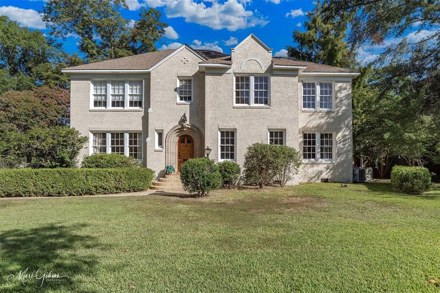 Welcome to a moment back in time where craftsmanship and character abound in this stately Glenwood home built in the 1940s. From the moment you arrive, the grandeur is unmistakable—graceful symmetry, timeless detail, and a presence that commands admiration. Step inside and you’ll feel its history blend seamlessly with modern comfort. If you’ve been searching for space, sophistication, and soul, this is it. The remodeled chef’s kitchen features a Wolf gas range, abundant storage, expansive counters, and a layout perfect for both everyday cooking and entertaining. Two dining areas offer room for gatherings large or small, while two spacious living rooms—each with a beautiful fireplace, hardwood floors, and ceramic tile, and original light fixtures—create a warm, inviting flow. An additional entertainment room with a bar provides flexibility for game nights or celebrations. Upstairs, you’ll find four bedrooms, two full baths, and access to a private deck ideal for morning coffee or evening sunsets. The back addition, designed by Weiner, complements the home’s original architecture while adding comfort and livability. Unique details like large swing doors, an original safe, and vintage features showcase its history, yet the home has been updated for today’s efficiency and convenience. This is not just a home—it’s a living piece of history where classic design meets modern function, offering timeless beauty, incredible space, and enduring charm in one of Glenwood’s most iconic settings.