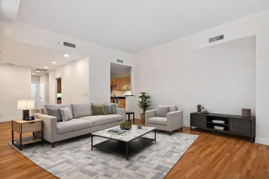 Stunning two-bedroom, 2.5-bath, two-story condo offering luxury living with concierge service and premium finishes throughout. The open-concept main level features granite countertops, stainless steel appliances in the kitchen, with rich wood flooring throughout, perfect for both everyday living and entertaining. Private secondary bedroom on 1st floor with ensuite bath. Spacious primary bedroom upstairs with travertine countertops and matching travertine flooring, creating a spa-like retreat. Thoughtfully designed layout provides privacy, functionality, and modern elegance. Private balcony through the living room and the primary bedroom. Enjoy a lock-and-leave lifestyle with building amenities, secure access, and a prime location close to shopping, dining, and major conveniences. Ideal for professionals, investors, or anyone seeking upscale, low-maintenance living.