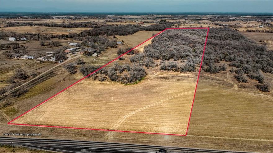 Just over 29 acres in Boyd Texas offers a prime opportunity to own quality land in a desirable rural setting. Located outside the city limits in Boyd ISD with paved frontage on Farm to Market Road 2048 this property combines convenience with the freedom of country living.  The land features an attractive mix of open pasture and mature trees creating a scenic and highly usable tract that is well suited for an end user looking to build a home ranch or weekend retreat. It also presents a strong buy and hold investment opportunity with long term potential.  An agricultural exemption is currently in place helping keep property taxes low. Water and electricity are available at the road allowing for straightforward future development. An additional adjacent 29 acres is available for those looking to expand or increase their investment footprint.