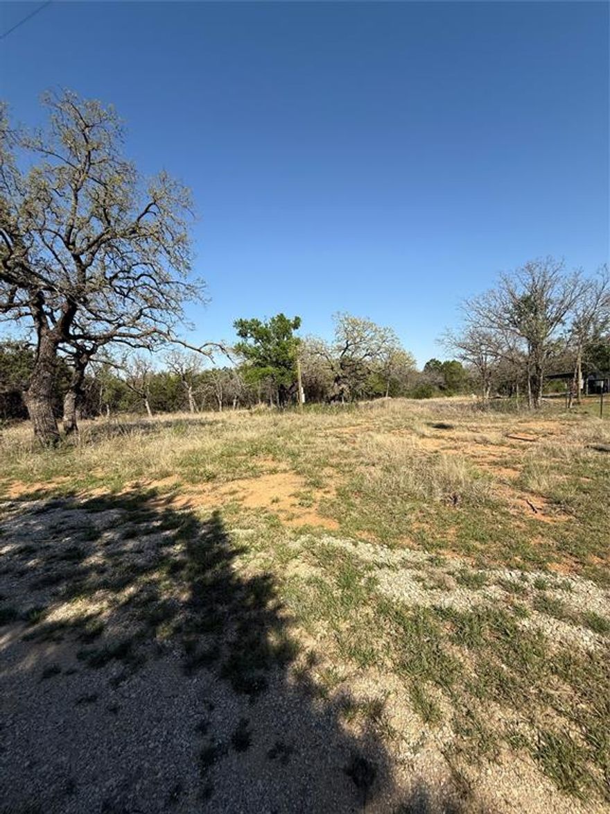 Tucked away on a beautiful one-acre, tree-filled lot, this property offers the perfect blend of peaceful country living and close-to-town convenience. Located just minutes from downtown Mineral Wells, you’ll enjoy the charm of small-town shops, dining, and local events while still having space to spread out and unwind.

The land features mature trees that provide natural shade and privacy, creating an inviting setting to build your dream home, weekend getaway, or investment property. Electricity is already run to the property, and a water tap has been approved. Buyer will need to purchase and install a septic system.

If you’re looking for a warm, scenic homesite with the feel of the country but easy access to everyday conveniences, this property is ready for your vision.
