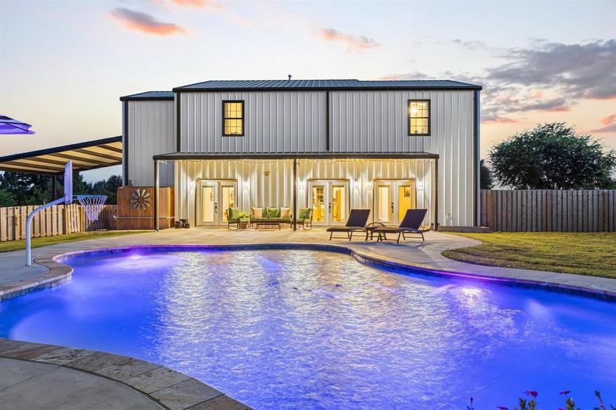 Built with love and designed for comfort and style, this stunning barndominium sits on 5 beautiful acres and offers the perfect blend of rustic charm and modern luxury. From the open-concept floor plan to the high-end finishes throughout, this home is truly one-of-a-kind. The heart of the home is a gorgeous kitchen featuring a large island, stainless steel appliances, granite countertops, and a commercial-grade gas range with double ovens. Perfect for everyday living and entertaining, this space is a chef’s dream. The downstairs primary suite is a retreat of its own, complete with private patio access and a spa-like en-suite. The wet room includes a freestanding soaking tub, dual shower heads, and a custom design that blends luxury with relaxation. The main living area is warm and inviting, showcasing a beautiful fireplace and two sets of glass doors that frame views of the back patio and sparkling pool. Upstairs, you’ll find another potential primary suite with its own attached bathroom and walk-in shower with bench. Two additional oversized bedrooms with walk-in closets are connected by a Jack-and-Jill bath featuring dual sinks, a spacious shower, and custom cabinetry. A large family room and a second laundry area add even more convenience. Step outside to a covered 8’ x 36’ back patio overlooking the resort-style pool. Complete with a tanning ledge, grotto, and waterfall feature, this backyard was made for Texas summers. A 40’ x 30’ metal shop with three overhead doors and plumbing for a bathroom makes the property ideal for hobbies, storage, or work.
Additional features include decorative lighting, spray foam insulation, a tankless water heater, and more. Conveniently located near Hwy 82, you’re just minutes from shopping, dining, and entertainment while still enjoying peaceful country living. This property is the epitome of Texas living—don’t miss the chance to make it yours!