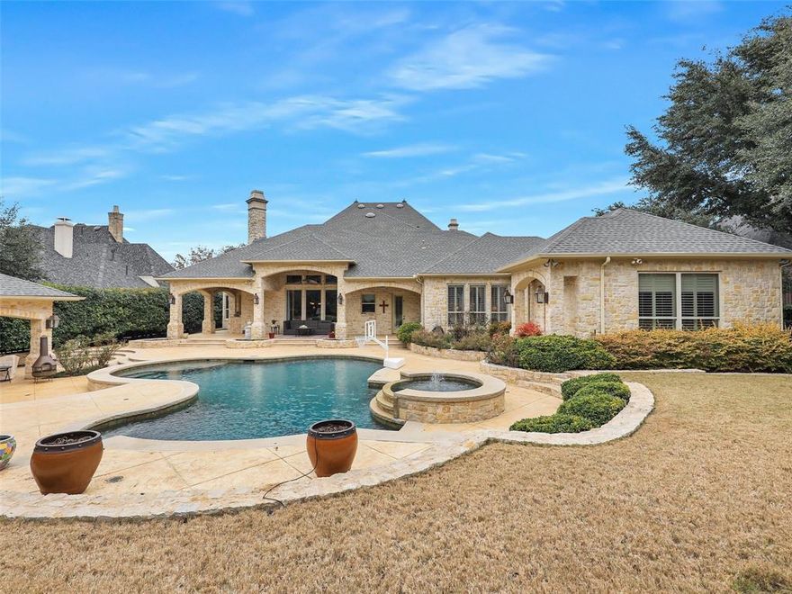 This 6,222-square-foot custom estate in the Villages of Stonebriar Park delivers scale, craftsmanship, and resort-style living on every level. A dramatic entry sets the tone with custom double front doors, a sweeping curved staircase, secondary rear staircase, and a soaring cathedral wood, dome ceiling crowned by an elegant chandelier. The main living spaces feature beamed ceilings, extensive crown molding, custom-built cabinetry, a wet bar, and a butler’s pantry designed for effortless entertaining. The chef’s kitchen is anchored by an oversized island with cleanup sink and warming drawers, with a built-in subzero refrigerator, microwave, and commercial-grade gas range. The adjacent breakfast room is highlighted by a slatted wood, dome ceiling, and has access to the backyard. The primary suite is a true retreat, offering a private sitting area, walk-in closet with peninsula with drawers, and a spa-inspired ensuite with a raised drop-in jetted tub, separate doorless, double shower, and direct access to a private gym. A downstairs guest suite includes its own ensuite bath and walk-in closet. Also on the main level are a dedicated study, media room with tiered seating and candy counter, laundry room, steel walled safe room and a mud room. Upstairs, a spacious game room with built-in desks and cabinets, accompanied by three additional bedrooms, each with ensuite bathrooms and walk-in closets. The backyard rivals a private resort with a heated 4ft to 9ft deep pool featuring a diving wall, water features, spa, and Baja shelf. Outdoor amenities continue with a gazebo with fireplace, built-in cabinetry and a TV, a patio featuring a built-in BBQ grill and 3 ceiling fans, expansive sundeck, and multiple spaces designed for year-round enjoyment. The 3 car split garage has inside access and built-in cabinets. This is a rare opportunity to own a meticulously designed luxury home where architectural detail meets livable elegance in one of Frisco’s most desirable communities.