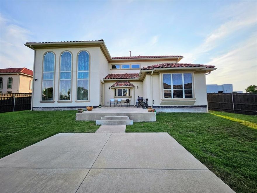 Custom Built Mediterranean Masterpiece—experience timeless elegance in this stunning custom-designed 5-bedroom, 4-bath home situated on one of the largest lots in the community. From the moment you enter through the grand cast iron front door, you are welcomed by soaring 20-foot ceilings, abundant natural light, and graceful architectural arches that enhance the open-concept design. The impressive family room features a dramatic 20-foot ceiling, expansive windows, and custom decorative brickwork, while a striking curved staircase and solid hardwood flooring add to the home’s sophisticated charm. Hardwood floors extend throughout the main level, excluding the kitchen and guest suite. The gourmet kitchen is a chef’s dream, complete with a 48-inch commercial-grade range with vent hood, custom cabinetry, a large stainless steel farmhouse sink, and 2cm granite countertops, which are also featured in all four bathrooms for a cohesive upscale finish. The thoughtfully designed layout includes two bedrooms on the main floor, including a spacious primary suite and a guest bedroom, offering both comfort and convenience. Additional highlights include 8-foot interior doors, a tankless instant water heater, extended front parking, and a stunning six-color Spanish brick tile roof accented with two decorative domes.