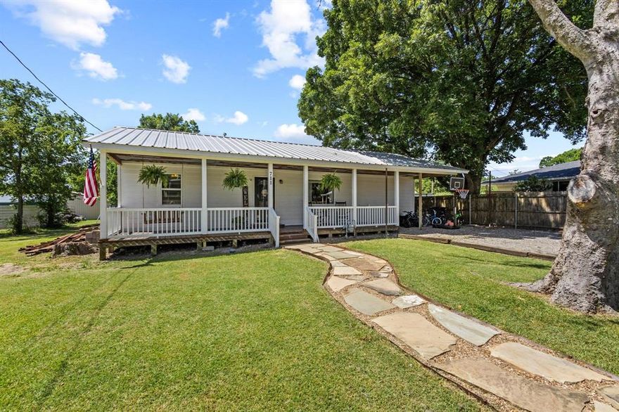 Small-town appeal meets everyday comfort in this adorable 4-bedroom, 2-bath home right in the heart of Wolfe City! From the moment you stroll up the stone walkway to the wide front porch, you’ll be in love.

Step inside to find thoughtful touches throughout—brick columns in the dining area, metal ceilings in the master suite, and added details like a barn door, double sinks, and a walk-in closet. The kitchen features a gas range, and there’s even a gas hookup in the living room for added convenience.