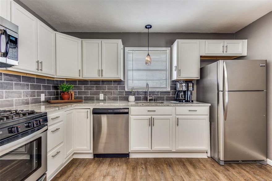 Updated throughout in 2018, this charmer located in the heart of Van Alstyne offers the perfect blend of modern convenience and comfortable living!  Situated on a generously sized, 0.16-acre, level lot, with a delightful array of features both inside and out, this home offers a relaxing retreat. Step inside to an open floor plan that effortlessly flows from room to room, making the most of every space. The interiors are graced with striking LVP flooring throughout the living, dining, kitchen and traffic areas providing a warm and inviting ambiance. Every kitchen detail has been carefully considered, including the eye-catching granite countertops, ample cabinetry which ensures plenty of storage space, deep single-bowl sink, and stainless-steel appliances that promise a contemporary cooking experience. The bathroom's oversized, ceramic tile flooring, designer tile tub-shower surround, built in linen cabinet, furniture style vanity, and updated lighting provide a luxurious aesthetic. Each of the two bedrooms are mirrored in size and feature neutral carpet, modern ceiling fans, and plenty of natural light. The separate utility room includes full size washer and dryer connections, houses the gas water heater, and provides convenient access to the rear patio. Outside, the fenced backyard delivers a vast canvas for outdoor entertainment or simply enjoying some rest and relaxation. A covered patio serves as an ideal spot for al fresco dining or morning coffees. The property is complete with a convenient, 10x9 storage building, offering space for all your outdoor gear and tools. This home marries the charm of small-town living with modern updates and conveniences, providing a welcoming space for its next owner. Don’t miss the chance to own this gem in Van Alstyne, where every detail has been carefully curated to offer the best in comfortable and stylish living.