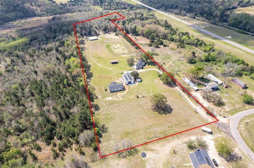 18.169 acre gated property in East Texas offering a rare combination of multiple residences, functional improvements, and recreational features. Designed for flexibility, this property is ideal for multi-generational living, income potential, or a private retreat with room to expand.

The main home features 3 bedrooms, 3 full bathrooms, and updated interior finishes, with flexible living and dining spaces. A second residence offers 3 bedrooms, 2 bathrooms, and an open-concept layout—ideal for extended family or rental use.

The property is well-equipped with multiple outbuildings, including two shops with water and electricity. One shop includes additional living space with bedrooms and a full bath, while the larger 2,000 SF shop offers the potential to be finished out as a third residence, workspace, or business use. A small barn and pole barn provide additional utility for livestock, storage, or equipment.

The 18+ acres offer a balanced mix of open pasture and mature woods, with a centrally located track for recreational or equestrian use complete with arena lighting. Additional features include RV hookups, solar panels for energy efficiency, and a gated entrance with concrete drive access.

Conveniently located near Tyler’s amenities while maintaining privacy and usable acreage, this property presents a unique opportunity with multiple use options.