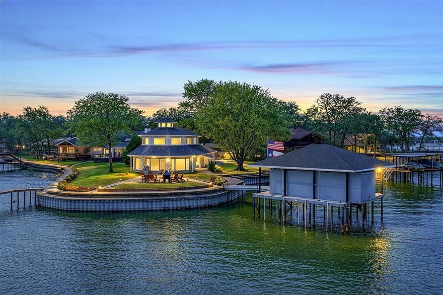 This extraordinary lakefront retreat is a true architectural gem, thoughtfully designed to echo the character of a classic ship, complete with porthole windows & striking custom angles. Perfectly positioned on a spectacular 173' open water point in gated Beachwood Estates, this property offers deep water and breathtaking panoramic views. Inside, the spacious, updated interior is designed for entertaining with open concept living spaces featuring dramatic octagonal, glass-walled design that floods the home with natural light and showcases sweeping 270° lake views. Modern upgrades abound, including smart home features with remote drop-down TV, luxury vinyl plank flooring, new carpet, granite countertops, KitchenAid stainless appliances, LED lighting, and numerous additional enhancements throughout. The primary suite is on the main level and offers an en-suite bath with jetted tub, separate shower, private atrium, and walk-in closet. A full guest bath is also located downstairs. Upstairs are 2 guest bedrooms, a full bath, and spacious 2nd living area ideal for office, game room, or additional bunk space. One of the most captivating features is the hidden pull-down staircase leading to the 3rd story crow’s nest lookout, the 360° views stretch for miles! Outdoor living is equally impressive with a large waterside patio complete with outdoor grill and classic wood Adirondack furniture, perfect for gathering with friends and family. The 2021 composite boat dock includes electric boat lift, dual PWC lifts, and remote boat cover. There is 2023 retaining wall; full irrigation with lake pump; audio-video security; 2 refrigerators, separate ice maker, washer & dryer; and 3-car garage with insulated doors & 220V outlet for your RV or camper. Offering an ideal blend of luxury, comfort, and lakeside adventure, this exceptional home makes a perfect full-time residence or weekend escape, conveniently located just one hour from downtown Dallas. Come live the lake life!