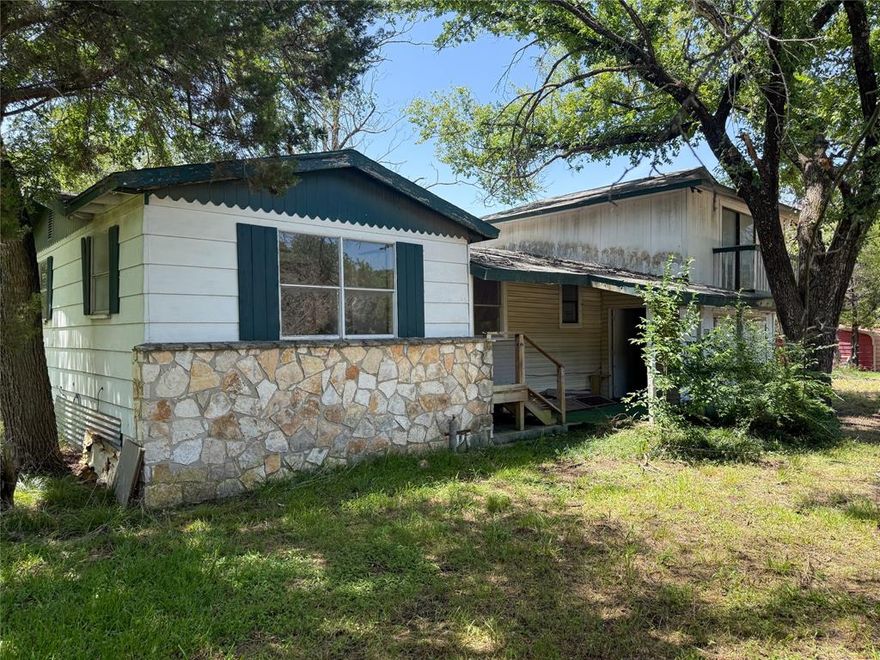 3 Bedroom, 2 Bathroom Home on 2 LOTS! This Property is a Great Investment in a Lake Whitney Community just minutes from the Boat Ramp and Parks. Primary Bedroom is upstairs above the garage. Mid Remodel, so new owner will be able to pick the finishing touches! Don't miss this Investment Opportunity!