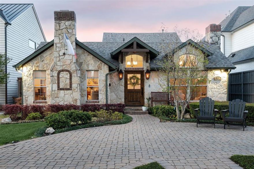 Set within the coveted Briarwood enclave, this distinguished residence blends timeless character with modern, family-friendly living. A thoughtfully designed floor plan offers four bedrooms, three full baths, multiple living and dining areas, and vaulted, detailed ceilings throughout. Three striking stone fireplaces anchor the home’s warm, inviting aesthetic.

The chef’s kitchen serves as the heart of the home, featuring premium stainless steel appliances, an oversized built-in refrigerator-freezer, pot filler, wine chiller, dedicated ice maker, and a spacious pantry—ideal for both daily living and entertaining. The primary suite provides a serene retreat with generous proportions, ample closet space and a freshly renovated bathroom.

Outdoor living is equally inviting, with a covered patio and elegant stone walkway suited for both quiet evenings and gatherings. Ideally located near Dallas’ premier shopping and dining, this home offers a rare combination of comfort, sophistication, and convenience.