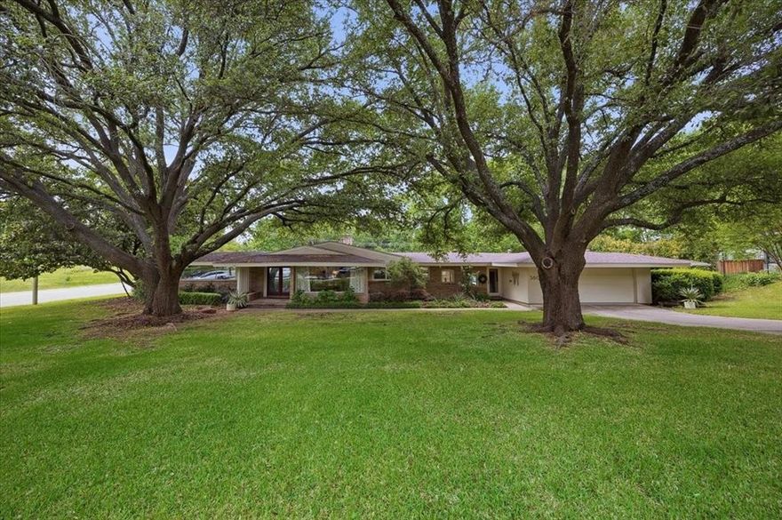 Don’t miss this one of a kind home in a great area close to TCU, shopping, and walking trails. Situated on a wonderful street, this home offers abundant natural light and a very private setting on a large corner lot with mature trees. The living room overlooks a charming courtyard, creating a peaceful and inviting space for relaxing or entertaining.
The backyard backs up to a greenbelt and features a pool and sport court. Inside, you will find marble flooring in the entry and office, custom lighting, and walls of windows throughout.
The home offers 3 bedrooms and 3.5 baths, plus an additional separate bedroom, office, or pool house with a full bath that is not included in the square footage, ideal for guests, a home office, or flexible living space.