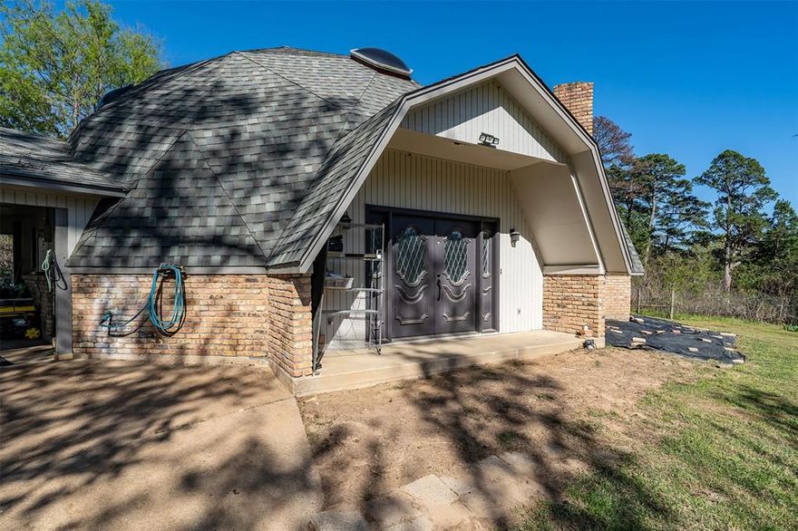 Unique dome home on 1.5 acres with space, character, and convenience! Located just minutes from Gladewater with easy access to I-20, this 3 bedroom, 2.5 bath home offers approximately 2,100 sq ft and a layout designed for comfortable living. The open living and dining combination features soaring ceilings that create a bright, spacious feel, while the dining area includes abundant built-in cabinetry for excellent storage. The generous kitchen offers plenty of cabinet space, a pantry, and a new oven, making it both functional and inviting. The large primary suite is located downstairs and features a private bath along with three closets for exceptional storage. A laundry room with a convenient half bath is also located on the main level. Upstairs you’ll find two guest bedrooms that share a full hall bath, providing privacy and flexibility for family or guests. Outdoor living is just as appealing with a patio and 20’x20’ pergola, fire pit area, new 16X20 shed, raised garden beds(approximately 50’x60’), and two fenced areas (totaling 1.5 acre) perfect for animals. The two-car carport already has AC in place and could easily be enclosed for additional living space, workshop, or hobby area. Plus a working well for outdoor use! And newer roof and AC! Situated on 1.5 acres in Gladewater ISD, this property offers a peaceful country feel while remaining conveniently located—approximately 30 minutes from Lindale, Tyler, and Longview. Come See! Come Buy!