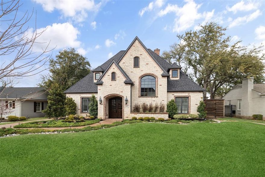 Nestled among mature trees and lush landscaping, this beautifully crafted stone traditional home in Preston Hollow exudes warmth and sophistication. Striking beveled double wooden doors open to a thoughtfully designed floor plan, where rich maple flooring and abundant natural light create a bright and inviting atmosphere. The spacious living area seamlessly flows into the gourmet kitchen- a chef’s dream- featuring granite countertops, dual islands, a walk-in pantry, top-of-the-line stainless steel appliances, dual dishwashers, a wine fridge, and a built-in desk area. The bright and airy kitchen includes a charming breakfast sitting area and connects effortlessly to the dining room, making it perfect for both casual mornings and formal gatherings. The main level boasts a generous primary suite with a cozy sitting area and large windows adorned with plantation shutters, offering serene views of the pool. The updated primary bath is light and bright, featuring dual sinks, built-in cabinetry, a separate soaking tub and shower, and a custom closet. A dedicated office and an additional bedroom on the main floor enhance the thoughtful layout. Upstairs, three ensuite bedrooms are separated by a versatile landing, ideal for a game room or media space. A second staircase leads to a workout room with additional storage. Designed for year-round enjoyment, the air-conditioned enclosed outdoor patio features a TV, sliding double doors, and breathtaking views of the pool and outdoor lounge area. The backyard is a true oasis, complete with a resort-style pool, a separate spa, a built-in stone fire pit, and an outdoor kitchen. Additional upgrades include a whole-home Eco water refining system, Flo by Moen water shut-off, a pool update in 2022, a new roof in 2020, and a kitchen remodel in 2020- along with many more enhancements. A rare opportunity to own a sophisticated home near top private schools, premier shopping, and fine dining.