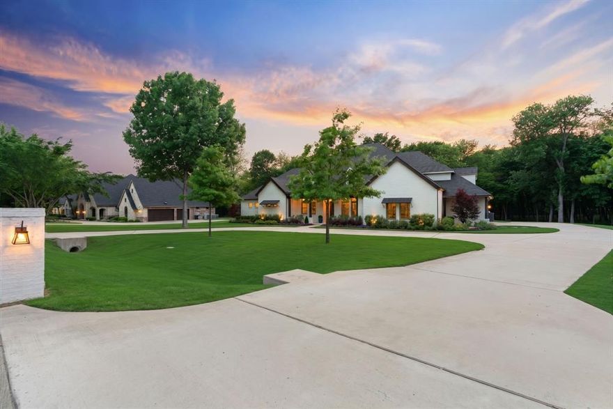 Welcome home to a refined, resort-inspired lifestyle in this stunning estate, privately situated on a two-acre lot with breathtaking sunset views in the sought-after Creekview Landing community of McKinney. Enjoy a peaceful setting just minutes from Historic Downtown McKinney, with convenient access to premier shopping, dining, and entertainment. Blending timeless architecture with elevated design, the home features mature landscaping, lush lawns, an expansive curved driveway with additional parking, and 3-car garage. Inside, a spacious, light-filled living room opens to the kitchen, highlighted by vaulted ceilings with exposed beams, a cozy fireplace, and hardwood flooring. The chef’s kitchen includes a walk-in pantry, farmhouse sink, gas cooktop, double ovens, spacious coffee bar area, and custom cabinetry, with generous counter space and storage. The layout offers all bedrooms on the main level with spacious closets and well-appointed baths, plus a versatile flex space ideal for dining or an executive study. The private owner’s suite features a sitting area overlooking the acreage and beautiful backyard oasis, a large walk-in closet, and a spa-inspired bath. Upstairs, a flex space with a half bath, perfect for a game room, media room, or guest retreat. Designed for modern living, the home includes Cat6A wiring, fiber internet and built-in storm shelter. The outdoor living experience is exceptional, offering a private, resort-style setting for both relaxation and entertaining. A stunning pool and heated spa are complemented by expansive lounging areas and low-maintenance turf, all framed by a wrought iron fence and open Texas skies. Whether hosting guests or enjoying quiet evenings at sunset, this space offers a seamless blend of luxury, privacy, and everyday escape. Plantation shutters and electric shades add comfort and sophistication throughout. This exceptional estate offers a rare combination of design, privacy, and elevated everyday living.