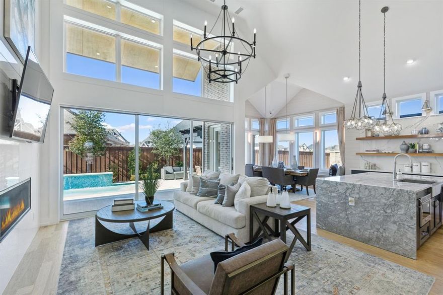 Grand Homes model home in South Pointe is now on the market, offering luxurious upgrades and designer finishes throughout. This spacious five-bedroom residence on a corner .25 acre lot features seven distinct living areas, providing ample room for comfort and flexibility. The formal living room boasts a cozy fireplace and built-in shelving, while an additional sitting area can be used as a reading nook or formal dining space. The private home office opens to the backyard and includes stylish barn doors for added privacy. A dramatic vaulted family room showcases large windows and a linear fireplace, flowing seamlessly into the open-concept kitchen, complete with a commercial-grade range, custom cabinetry, sleek countertops, and a convenient wet bar nearby. Perfect for guests, a private suite is located on the main floor. The primary suite is a true retreat, offering a luxurious bathroom with striking custom tile work. Upstairs, the layout is designed with kids in mind, featuring a game room, media room, and bonus space ideal for a children’s retreat, plus a built-in desk area for homework or creative projects. Step outside to a spacious backyard oasis, highlighted by a swimming pool and a deck overlooking the adjacent park. Mansfield’s premier master-planned community features resort-style amenities including a pool, parks, greenbelts, scenic trails, and a state-of-the-art amenity center—all within top-rated Mansfield ISD. This exceptional home blends high-end design with family-friendly functionality—schedule your private tour today.