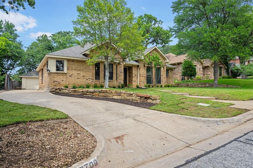 Updated 4-2-2 with new granite in the kitchen, fresh interior paint, and updated bathrooms. Located near Lake Arlington this 4 BD 2 bath has 2 living 2 dining plus large screened porch. Beautiful wood floors are found in the formal dining room as well as the two spacious living areas that share a dual-sided brick fireplace & built-ins. The kitchen features stainless steel appliances & custom tile backsplashes. A large screened sunroom in the back of the house provides a quiet space to relax & enjoy the view of the treed yard. The primary suite is split from the other 3 BRS & and has an ensuite bath with separate shower, dual sinks, a garden tub, and 2 walk-in walk in closets! The other 3 bedrooms and full bath are off the first living area, with a private hallway. The garage is at the end of the long driveway, separate from the house, an ideal workshop space. Wooded backyard with no house behind this one. Walking distance to Miller Elementary, as well as the lake, public boat ramp and Bowman Springs park.  Restaurants, shopping centers and lake life are nearby!