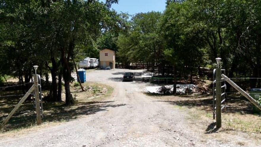 1.1 acres of gently wooded land, with two live creeks offering natural beauty, seasonal flow, and serene ambiance. A small building crafted as a studio upstairs (ideal for creative work, guest lodging, or a getaway retreat) with storage space below perfect as a base camp or hobby workshop. Electric wiring in place and plumbing rough-in installed; ready for water and septic hookups. No municipal utilities yet—underground electric ready, plumbing prepped, giving you a clean slate to finish to your own vision. County did say property is grandfathered in  to drill water well.