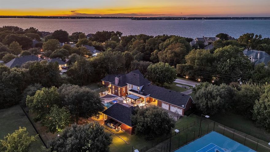 Welcome to this exceptional one and half story brick home on over an acre in the heart of Heath, where elegance meets privacy and functionality. This 4 bedroom, 3 bath residence offers a rare combination of space, craftsmanship, and resort style living, all with no HOA plus just minutes from the lake, parks, and Rockwall Harbor.

Step through massive double iron doors to find soaring vaulted ceilings with crown molding, a spacious office with glass French doors, and fresh luxury vinyl and new carpet throughout. The chef’s kitchen features a gas cooktop, double ovens, under cabinet lighting plus a wine room with a dry bar and wine fridge, perfect for entertaining. The oversized primary suite is a private sanctuary with porch access, a sitting area, and custom walk in closet, complete with a locking jewelry box. The spa like bath features copper double basins, a jetted tub, and a stand alone shower. 

Outdoors, your private paradise awaits. A 40k gallon custom salt pool with hot tub, twin waterfalls, diving board. The entire 1,750 sq ft granite porch deck was added in 2024 and offers abundant space for relaxing or hosting gatherings complete with a built in fire pit. Lush trees, meticulous landscaping, a circle drive with electric iron gate and port cochere, with a 3 car garage and built in safe. 

In 2021, the detached pool house was transformed into a fully functioning guest quarters with a large bedroom, including walk in closet, full bath, kitchen and private granite patio ideal for guests, multigenerational living, or potential income.

Every detail has been thoughtfully curated, from remote controlled blinds and custom draperies to an outdoor speaker system. Recent renovations include resurfaced pool and walls (2024), upgraded porch with brushed granite “stay cool” decking. Inside home includes luxury vinyl and carpet (2025) and fresh paint.