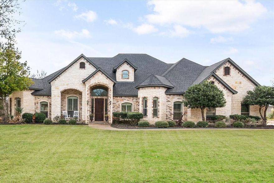 NEW IMPROVED PRICE ON A SPECTACULAR HOME!  A rare opportunity to own a luxury retreat on almost 1.5 acres in one of Midlothian’s most desirable neighborhoods. This exceptional property offers the perfect balance of refined living and natural surroundings, set on a heavily wooded lot backing to a tranquil creek. The main residence features 5 bedrooms and 4 full bathrooms, thoughtfully designed with hardwood floors, fresh interior paint, and new carpet.  Custom details elevate the home, including built-in cabinetry, designer lighting, and timeless finishes that blend elegance with comfort. A spacious 3-car garage provides ample storage and functionality. Upstairs, the home offers exceptional flexibility with both a dedicated media room and an additional living area, creating ideal spaces for entertainment, relaxation and everyday living. Together, these areas enhance the home’s livability, making it ideal for gatherings, multi-generational living or simply enjoying quiet moments away from the main living spaces. Step outside to experience resort-style living with a stunning infinity-edge pool, outdoor entertaining areas and a fire pit, ideal for evenings spent under the stars. The expansive yard invites exploration, where kids can roam, play, and experience the outdoors in a way that’s increasingly rare. A standout feature of the property is the semi-finished guest house, thoughtfully designed to allow the next owner to complete it to their personal taste. With a bedroom, full bath, open living and kitchen space, a stunning outdoor living area featuring a stone fireplace, grill, and sink, this space offers endless possibilities including multi-generational living, a private office or guest accommodations. This is more than a home—it’s a lifestyle. A private, warm, luxury property with acreage, natural beauty, and flexibility, all just minutes from Midlothian amenities and easy access to Dallas and Fort Worth.